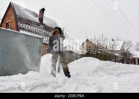 Non exclusif: HAVRYLIVKA, UKRAINE - 12 FÉVRIER 2021 - UN homme pique la neige à l'extérieur d'une maison dans le village de Havrylivka, région de Kiev, dans le nord de l'Ukraine. Banque D'Images