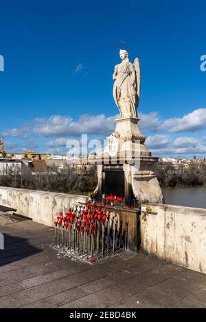 Cordoue, Espagne - 30 janvier 2021 : statue aux bougies et offrandes sur le pont romain de Cordoue Banque D'Images