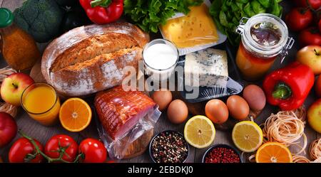 Assortiment de produits biologiques sur une table de cuisine en bois. Banque D'Images