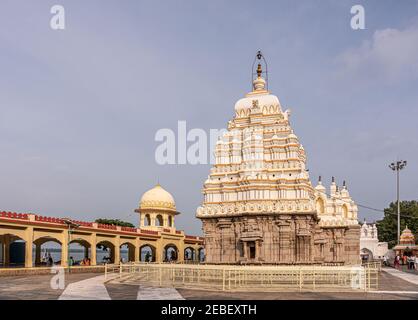 Bagalkot, Karnataka, Inde - 8 novembre 2013 : pierre brune avec vimanam blanc-jaune du temple de Sri Sangameshwar sous un paysage bleu et des gens aroun Banque D'Images