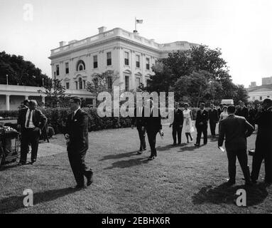 Visite de la classe Senior de Glen Lake (Michigan) High School, 9:50. John J. McNally (à gauche), adjoint spécial du président, dirige les membres de la classe supérieure de la Glen Lake High School (Maple City, Michigan) le long de la pelouse de l'aile ouest de la Maison Blanche. Tous les autres sont non identifiés. Washington, D.C. [Veuillez consulter les dossiers du personnel de la Maison-Blanche de John J. McNally, série 7. Photographies, 1961-1963, pour une liste complète de la classe senior.] Banque D'Images