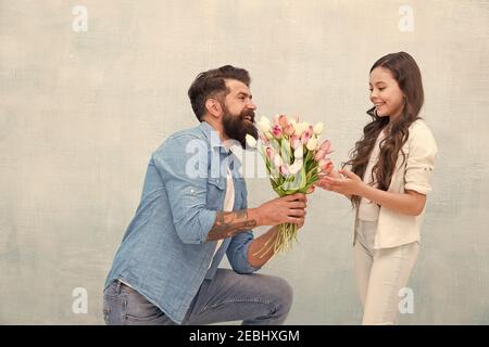 C'est pour vous une petite princesse. Journée familiale. Passer du temps ensemble. Fille prendre des tulipes. Heureux père a reçu don le jour des pères. 8 mars. Happy Women Day. Papa donner des fleurs à une petite fille en vacances Banque D'Images