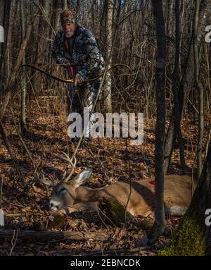 Hunter tenant son arc et sa flèche récursive faits sur mesure alors qu'il approche de sa mort dans le nord du Wisconsin. Banque D'Images