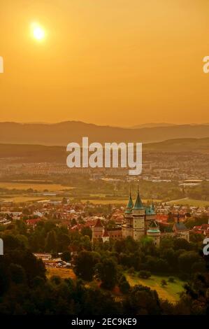 Belle vue aérienne sur le château de Bojnice et la ville de Bojnice dans une lumière jaune chaude au lever du soleil Banque D'Images