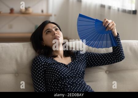 Une jeune femme asiatique exténuée se souffrait de chaleur extrême Banque D'Images