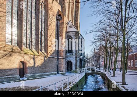 Delft, pays-Bas, 13 février 2021 : l'ancienne église et le canal Oude Delft par une journée ensoleillée en hiver Banque D'Images