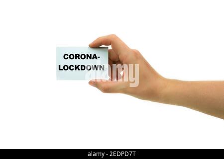 Main avec le lettrage de carte de visite Corona-Lockdown, Allemagne Banque D'Images