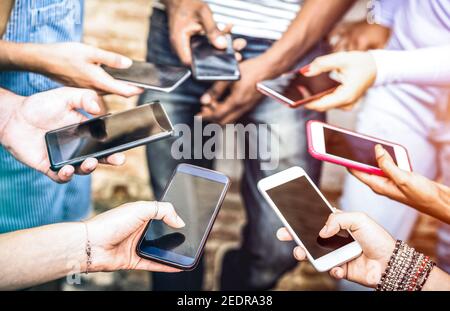 Groupe d'amis ayant addicted fun ensemble à l'aide de smartphones - mains partage détaillé de contenu sur les réseaux sociaux avec un smartphone mobile Banque D'Images