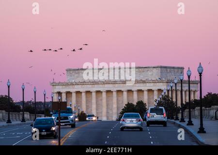 Le ciel devient rose pâle après le coucher du soleil, tandis que les voitures traversent le pont Arlington Memorial Bridge. Le Lincoln Memorial peut être vu dans l'arrière-gro Banque D'Images