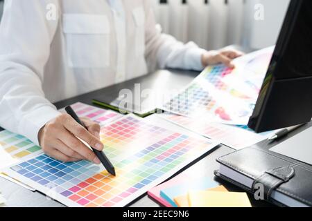 décorateur d'intérieur ou graphiste créatif travaillant sur le projet architectural avec échantillons de couleur avec outils de travail et équipement de sélection en position d'arrêt Banque D'Images