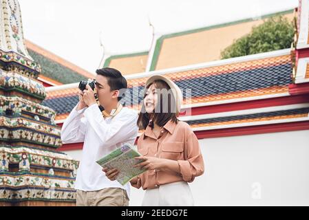 Couple asiatique touristes visitant le temple thaïlandais, Wat Phra Chetuphon (Wat Pho), à Bangkok Thaïlande pendant les vacances d'été Banque D'Images