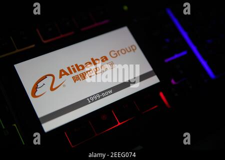 Viersen, Allemagne - février 9. 2021: Gros plan de l'écran de smartphone avec le logo du groupe alibaba sur un clavier d'ordinateur flou Banque D'Images