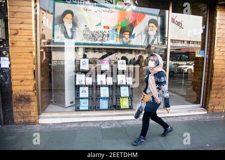 Téhéran, Iran. 16 février 2021. Les portraits du chef suprême de l'Iran, l'ayatollah Ali Khamenei et du défunt dirigeant de l'Iran, l'ayatollah Khomeini, se reflètent dans une fenêtre de librairie dans la rue Enghelab (Révolution), à Téhéran, en Iran. Depuis le début du mois de février 2021, le nombre de personnes infectées par le coronavirus augmente en Iran. (Photo de Sobhan Farajvan/Pacific Press) crédit: Pacific Press Media production Corp./Alay Live News Banque D'Images