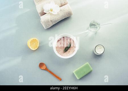 Sel de l'Himalaya dans un bol pour le soin de la peau. Citron, savon organique et serviette. Cosmétiques naturels et concept spa. Vue de dessus, plan d'appartement. Banque D'Images