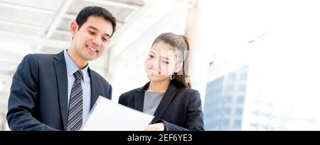 Homme d'affaires et femme d'affaires asiatiques discutant de document, bannière panoramique Banque D'Images