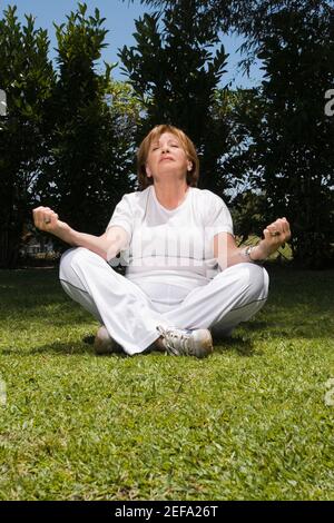 Senior woman sitting in lotus position Banque D'Images