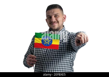 Homme blanc tenant un drapeau de l'Ethiopie et pointe en avant devant lui isolé sur un fond blanc. Banque D'Images