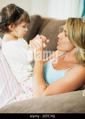 Portrait of a Mid adult woman Playing with her daughter Banque D'Images