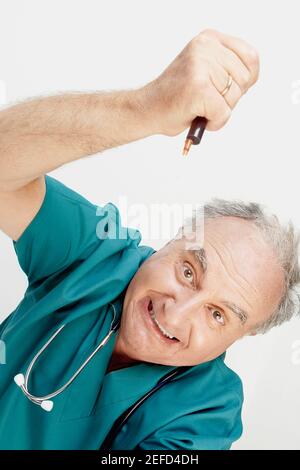 Portrait d'un médecin masculin tenant un stylo Banque D'Images