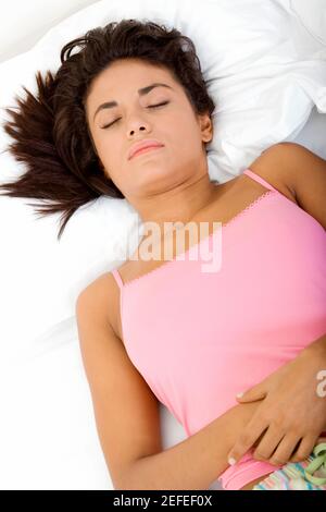 High angle view of a young woman sleeping on a bed Banque D'Images