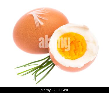 Œuf bouilli avec ciboulette sur fond blanc Banque D'Images