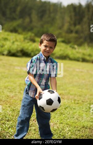 Portrait of a Boy holding a soccer ball Banque D'Images