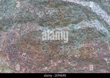 Texture d'une pierre de granit rouge avec des intempéries structure de grunge vieillie Banque D'Images