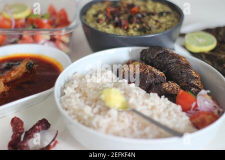 Plats au Kerala avec riz rouge, curry de sardines, friture de sardine et curry de gramme vert à base de noix de coco. Tous préparés dans le style traditionnel du kerala Banque D'Images