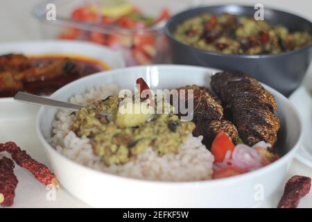 Plats au Kerala avec riz rouge, curry de sardines, friture de sardine et curry de gramme vert à base de noix de coco. Tous préparés dans le style traditionnel du kerala Banque D'Images
