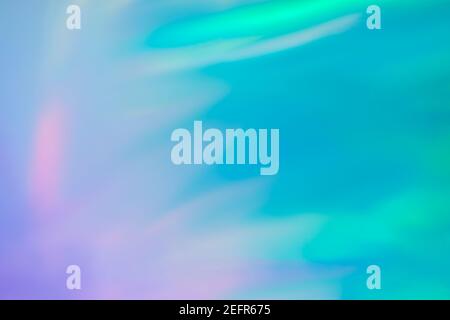 Fond abstrait flou en feuilles holographiques pour un design tendance. Carte fantaisie colorée. Couverture holographique étincelante aux couleurs pastel douces Banque D'Images