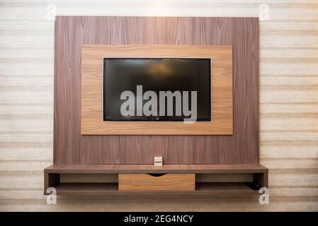 Smart TV dans un mur en bois dans un appartement confortable Banque D'Images