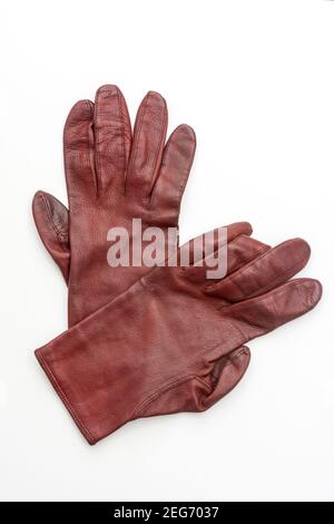 Gants en cuir marron affichés sur un fond blanc dans un cadre minimaliste adapté à la mode ou à la promotion d'accessoires Banque D'Images