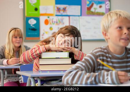 Les jeunes enfants dormant dans la salle de classe Banque D'Images