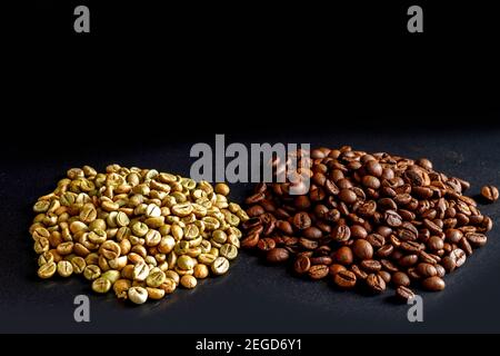 Grains de café non torréfiés et torréfiés de la variété Robusta sur fond noir. Café vert non torréfié à gauche et rôti brun à droite sur un Banque D'Images