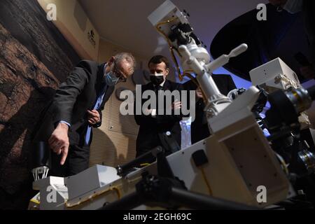 Le président français Emmanuel Macron (C) examine un modèle 3D de l'instrument SuperCam exposé au Centre national français d'études spatiales (CNES) lors d'une visite pour assister à l'atterrissage de la persévérance de la NASA Mars rover sur la planète Mars, à Paris le 18 février 2021. Le rover d'exploration de Mars recherchera des signes de vie microbienne ancienne et recueillera des échantillons de roche pour un retour futur sur Terre afin d'étudier la géologie et le climat de la planète rouge, ouvrant la voie à l'exploration humaine. La persévérance porte également l'hélicoptère expérimental Ingenuity Mars - qui va tenter le premier puissant, controll Banque D'Images