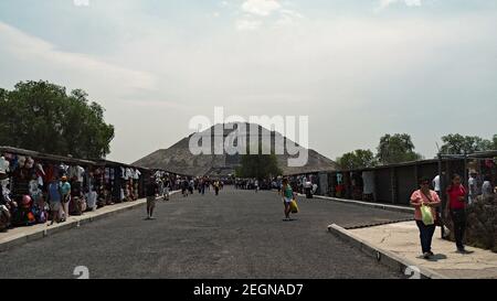 MEXIQUE, TEOTIHUACAN - 29 AVRIL 2017 - boutiques de souvenirs de Teotihuacan à l'entrée avec pyramide du soleil sur le fond et les touristes marchant Banque D'Images