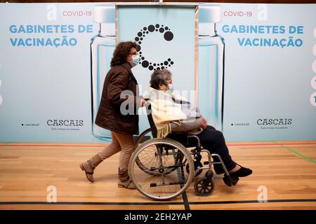 Lisbonne, Portugal. 18 février 2021. Les gens marchent devant les cabines de vaccination après avoir été inoculés avec le vaccin Pfizer-BioNTech COVID-19 au complexe sportif de Sao Domingos de Rana, à Cascais, Lisbonne, Portugal, le 18 février, 2021. Credit: Pedro Fiuza/Xinhua/Alamy Live News Banque D'Images