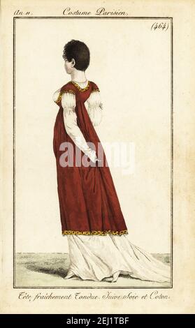 Femme à la mode dans la coiffure a la Victime. Ses cheveux sont fraîchement coupés, et elle porte une robe de chambre et une robe de chambre en soie et coton. Tête fraîement Tonndue. Unique Juive Soie et coton. Gravure en plaque de coperplate de couleur main du Journal des Dames et des modes de Pierre de la Mesangère, Magazine des femmes et de la mode, Paris, an 11, 1803. Illustrations de Carle Vernet, Jean-François Bosio, Dominique Bosio et Philibert Louis Debucourt, gravées par Pierre-Charles Baquoy. Banque D'Images