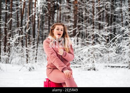 Fille vote dans les bois par une voiture cassée.Forêt d'hiver, le gel et la neige Banque D'Images