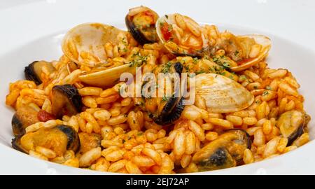 Délicieux risotto aux fruits de mer, risotto ai frutti di mare, sur un plat blanc. Gros plan Banque D'Images