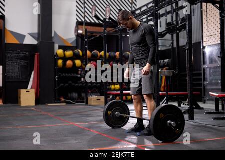 sportif se préparant à lever le poids de barbell dans la salle de fitness. espace de copie pour annoncer le texte ou le message texte. entraînement fonctionnel et coupe croisée con Banque D'Images