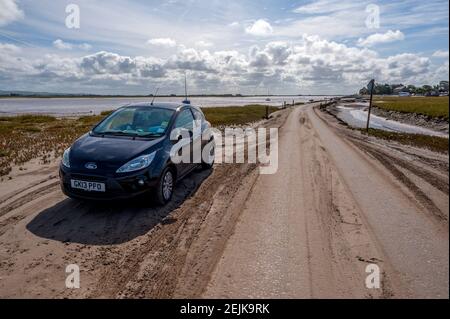 Voiture au début de la route de marée reliant Sunderland point et Morecambe, le long des rives de la Lune Banque D'Images