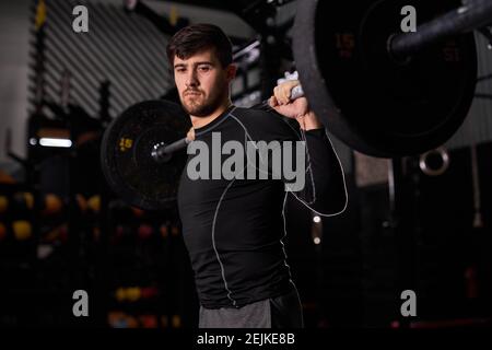 bodybuilder gars se préparer à faire des exercices avec barbell dans le centre de fitness moderne sombre ou salle de gym.la main de bodybuilder est liftingbarbell et l'exercice, seul, Banque D'Images