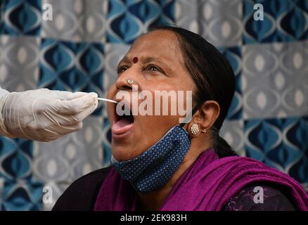 Un professionnel de la santé recueille un échantillon d'écouvillonnage auprès d'une femme résidant dans une colonie de taudis à Dharavi.les cas de virus Corona ont augmenté dans l'état de Maharashtra après le confinement. Il a été conseillé aux gens de ne pas se rassembler en grand nombre dans les lieux publics, de maintenir une distance sociale, de porter un masque et de se désinfecter les mains régulièrement. Banque D'Images