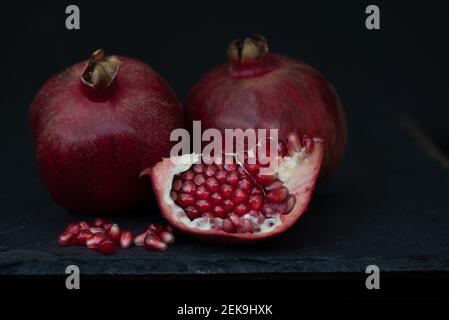 Deux fruits de grenade, l'un ensemble et d'une table en bois, contre, vue du dessus- concept alimentation saine Banque D'Images