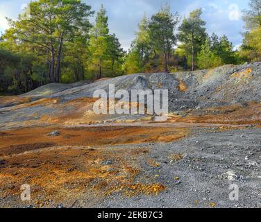 Des piles de roches multicolores dans une forêt, des résidus provenant de l'extraction de pyrite dans une mine de cuivre à ciel ouvert abandonnée Banque D'Images