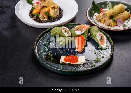 Délicieuses crêpes fraîches et sucrées sur une assiette avec du poisson rouge et du caviar. Délicieux petit déjeuner copieux Banque D'Images