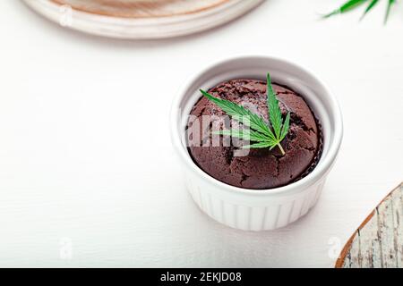 Muffins au chocolat avec de l'herbe de cannabis cbd. Médicaments marijuana chanvre drogues dans le dessert alimentaire. Cuisson des muffins aux mauvaises herbes au chocolat. Cupcake avec ma Banque D'Images