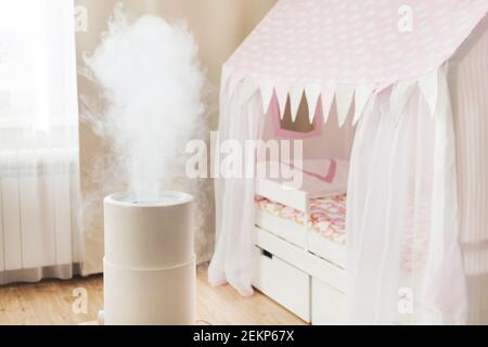 Humidificateur d'air moderne dans la chambre des enfants, diffuseur d'huile aromatique à la maison. Améliorer le confort de vivre dans une maison, améliorer le bien-être. Soins de bébé Banque D'Images