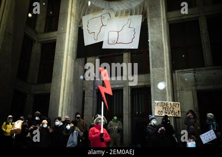 Un manifestant à l'intérieur est vu tenant un éclairage rouge, le symbole de la grève des femmes pendant la manifestation. Les médias sociaux sont des symboles d'aimer et de déaimer Banque D'Images